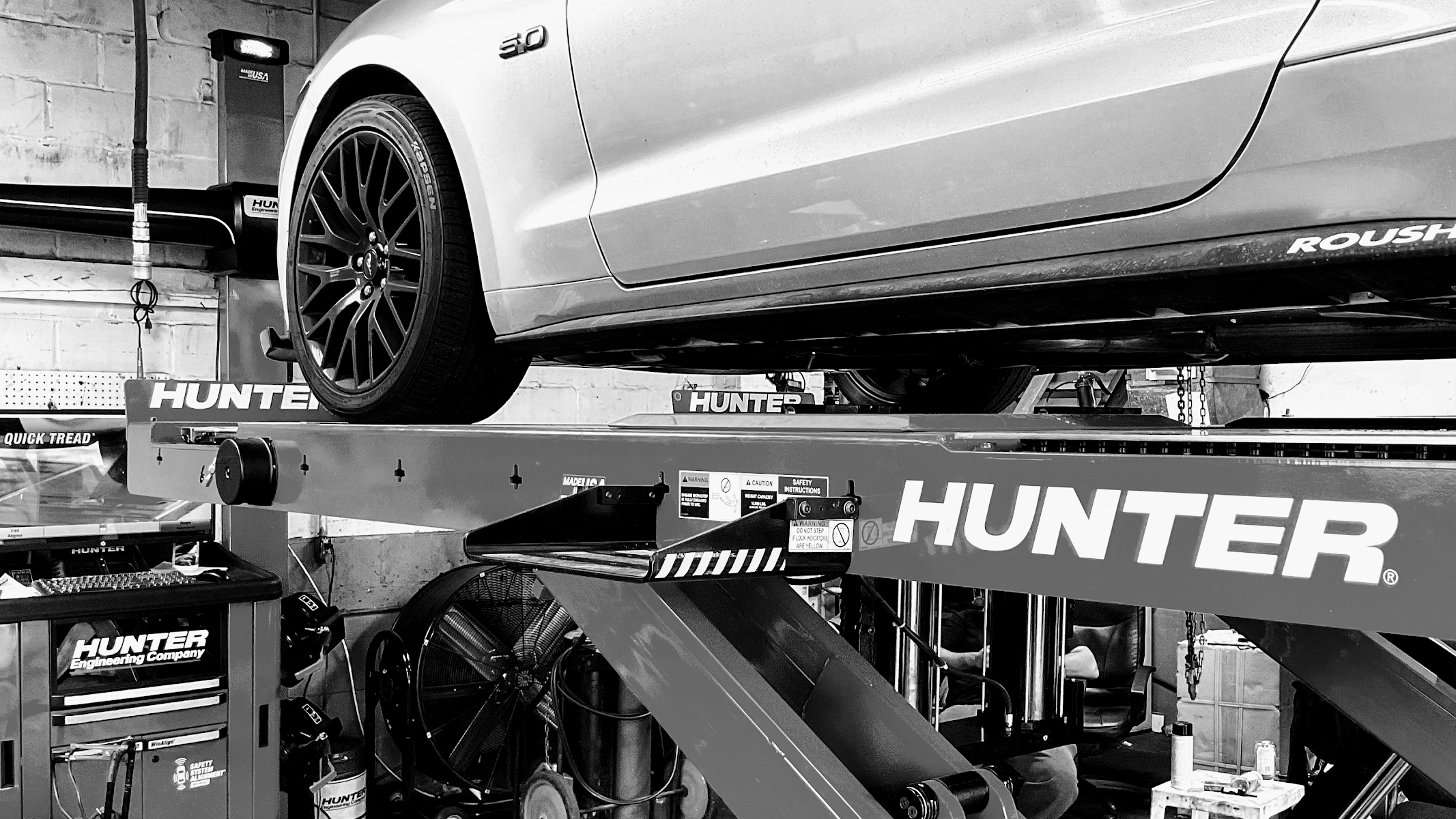 Car on a Hunter alignment rack inside Bhalli Auto & Repair